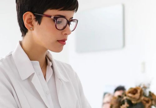 charming-female-doctor-typing-on-a-keyboard-35KUS4A